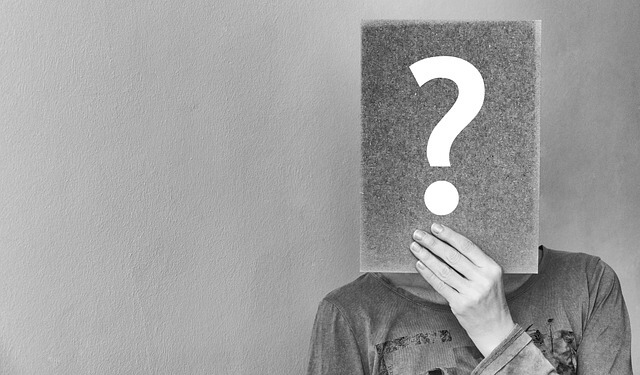 a person holding a question mark 